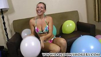 Busty teen pops balloons in bikini