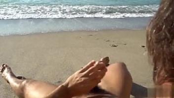 Two gay friends stroking at the beach