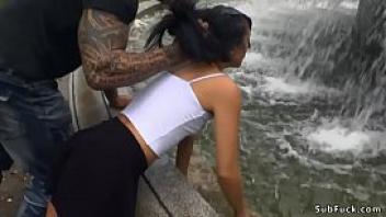 Slim brunette wet at public fountain