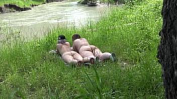 Voyeur outdoors peeps at two naked lesbians nudists with big asses sunbathe and enjoy nature and masturbation