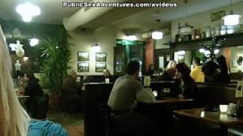 Blonde girl showing tits in the cafe