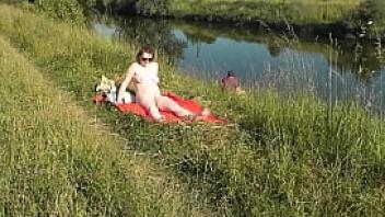 Milf sexy frina on river bank undressed and sunbathes naked random man fisherman watching for her and in the end decided to join naked woman wild beach nudist beach public nudity public exposure naked in public