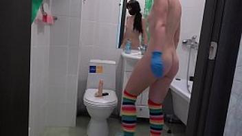Brunette in gloves masturbates in the toilet dildo in pussy and fisting to