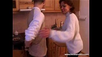 Mature mom and young guy on the kitchen