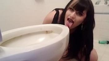 Goth girl licks toilet with a tampon