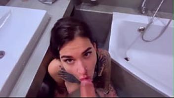 Tattooslutwife sucks a big cock in the bathroom gets a load in big mouth