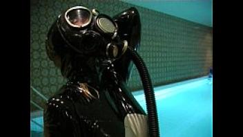 Breath play in latex catsuit and gas mask