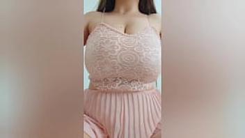 Young cutie in pink dress playing with her big tits in front of the camera depravedminx