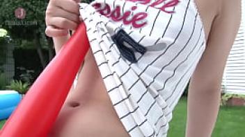 A beautiful white short cut girl has a baseball bat between her tits