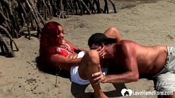 Redhead chick sucking cock and riding on beach