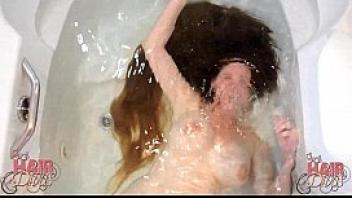 Longhaired blonde milf dunking head in water