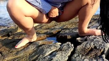 Wife pees outdoor on the beach