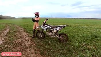 Naked woman riding a dirt bike